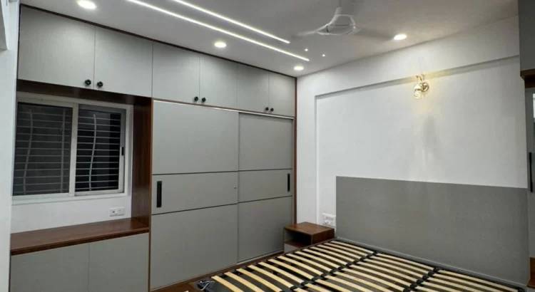 Modern bedroom design by interior designers near Mysore Road with sleek storage and ceiling lights.