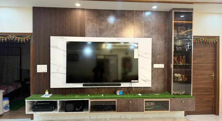 Modern TV cabinet with marble-finish base and glass display, designed by the best interior designer in JP Nagar Bangalore.