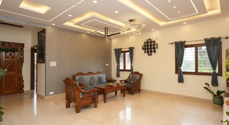 Living room by Interior Designers Near Banashankari with wood & modern lighting.