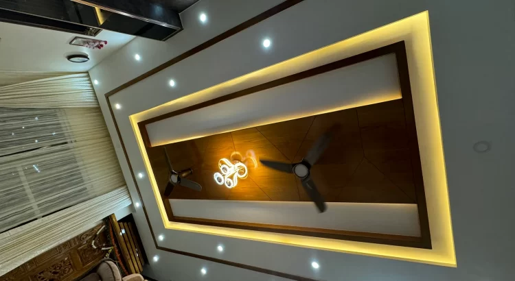 Modern luxury false ceiling design with layered lighting by interior services near Mysore Road
